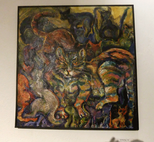 Cat painting with one big colorful tabby cat portrait and 11 other colorful cats fit into the negative space of the acrylic painting.